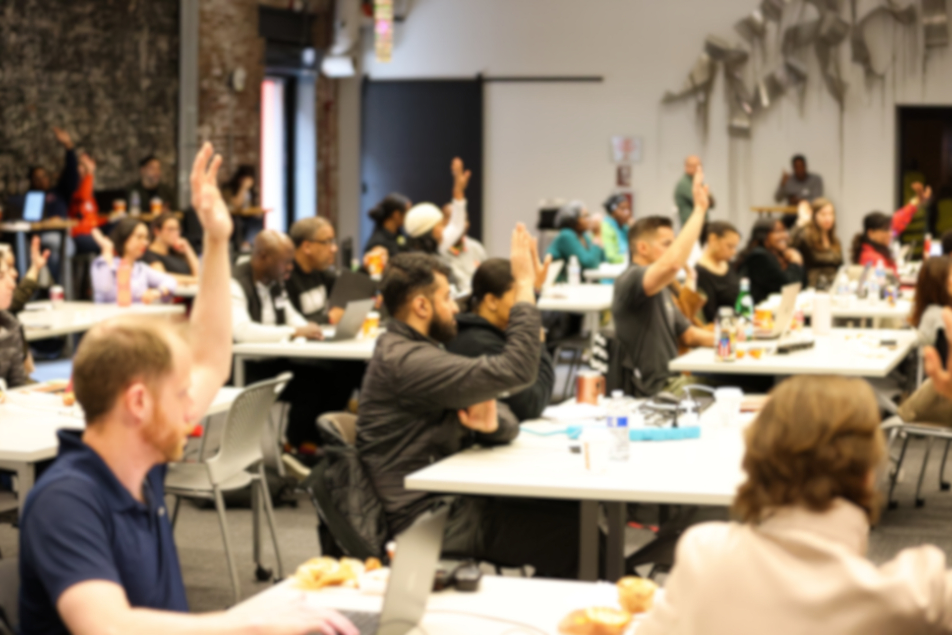 Audience engaged at a Miss ChatGPT101 workshop, hands raised